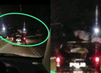 Tular kain putih atas kereta polis dipercayai pocong, nak pergi mana tu?